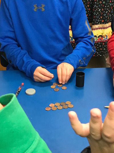 Child counting with coins to experience learning methods