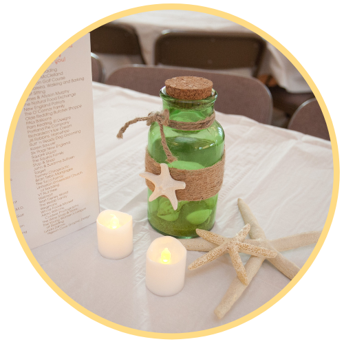 Gala Green bottle and electric candles on a white tablecloth